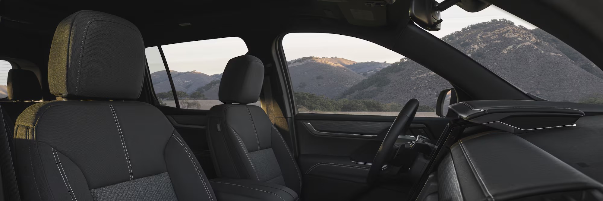 Side view of the front interiors of the 2025 GMC Acadia. width=