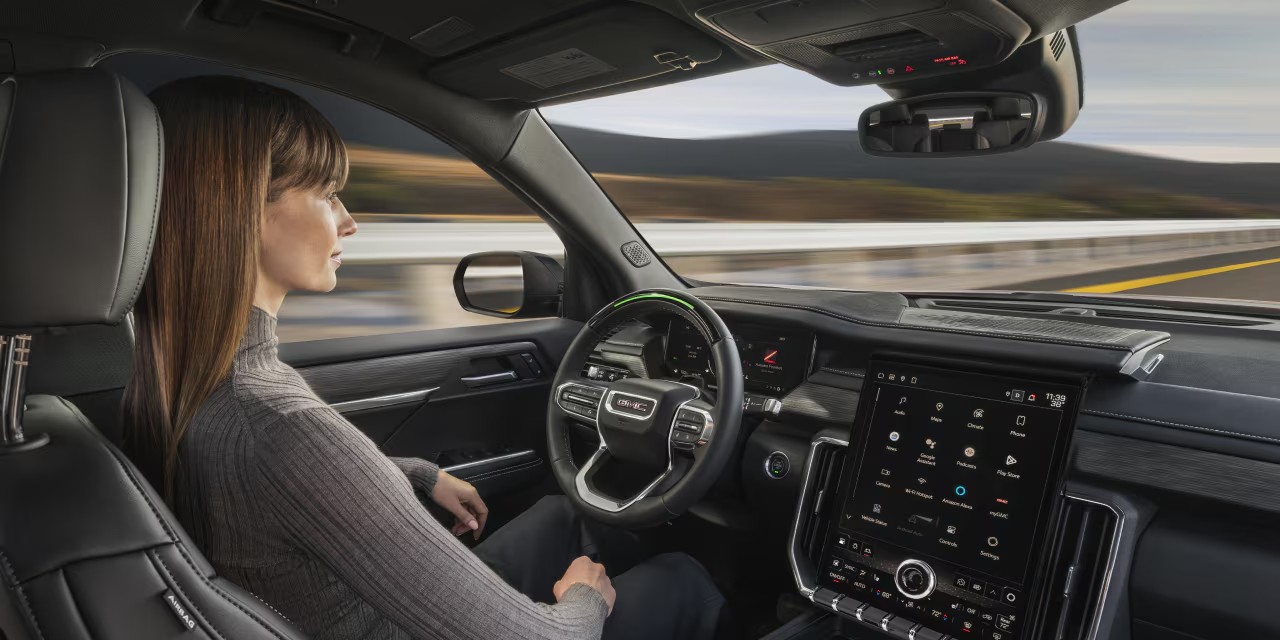 Side view of a person utilizing the Super Cruise technology on the 2025 GMC Acadia.